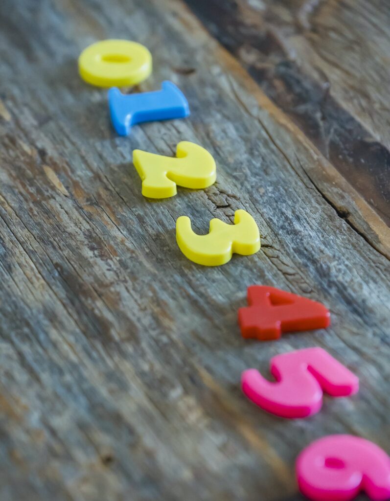 Multicolored numbers for counting on wooden table